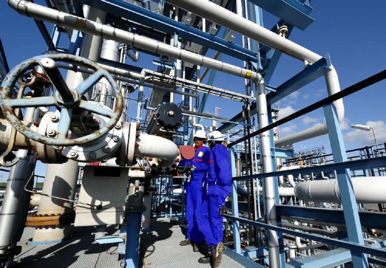 Maintenance crew inspecting industrial piping