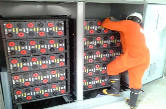 Technician installing 120 volt 60AH battery modules